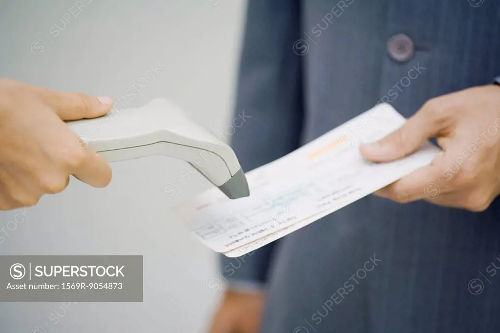Man´s plane tickets being scanned