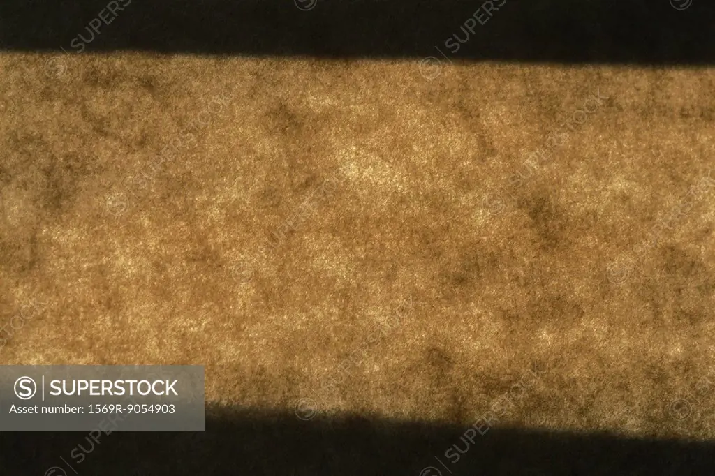 Light and shadow on brown surface