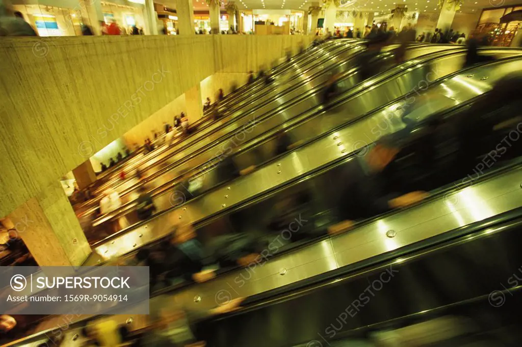 Escalators in crowded shopping mall