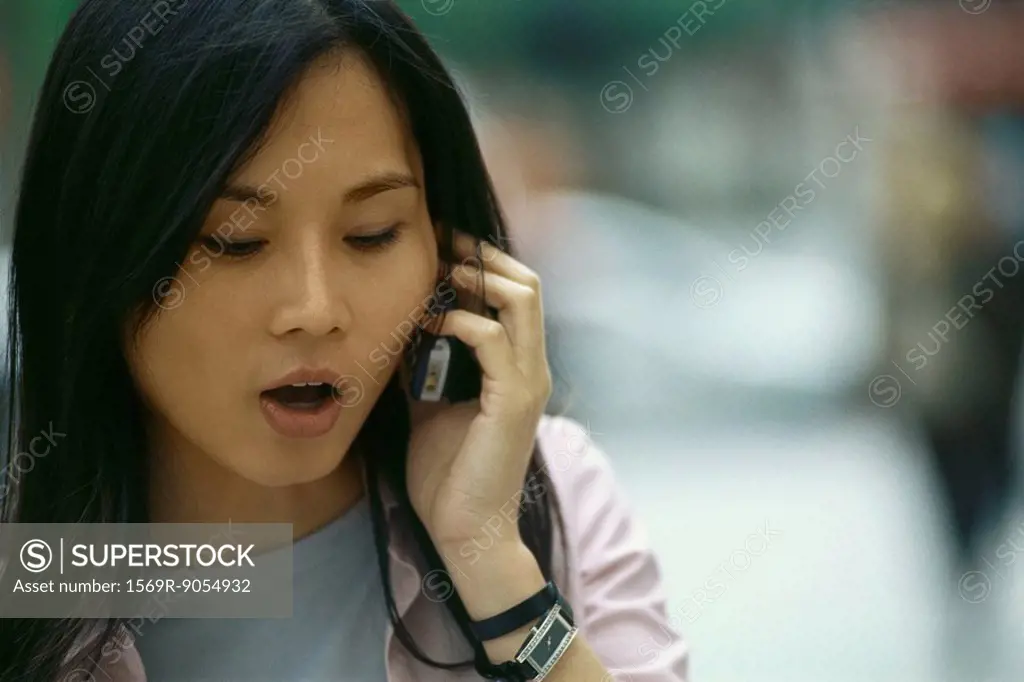 Woman talking on cell phone, close-up