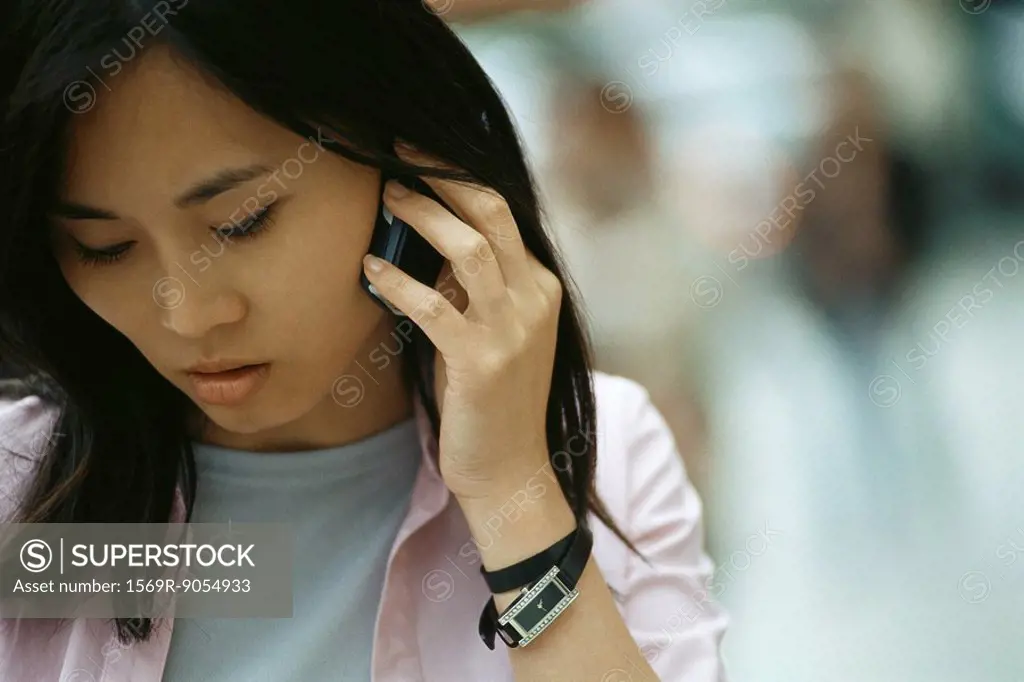 Woman using cell phone, looking down