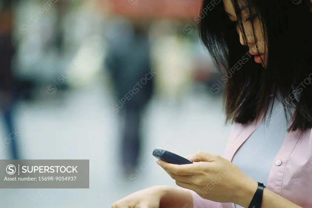 Woman text messaging with cell phone