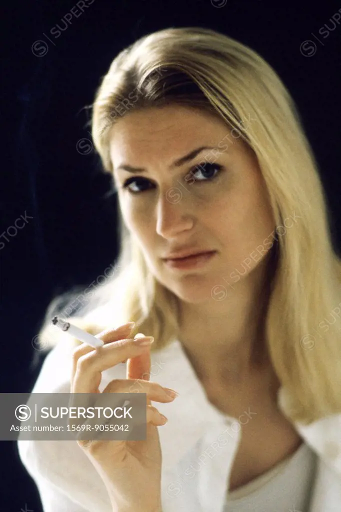 Woman holding cigarette, portrait