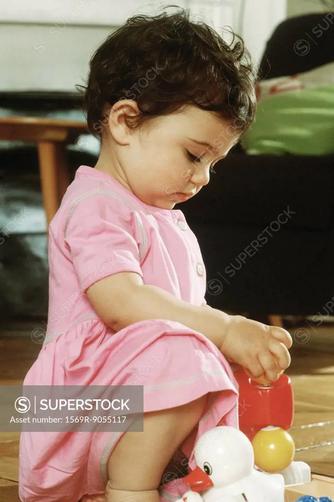 Little girl playing with toys