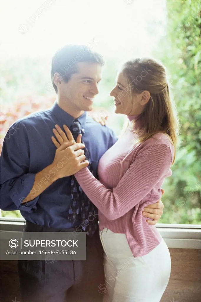 Couple embracing, smiling at each other