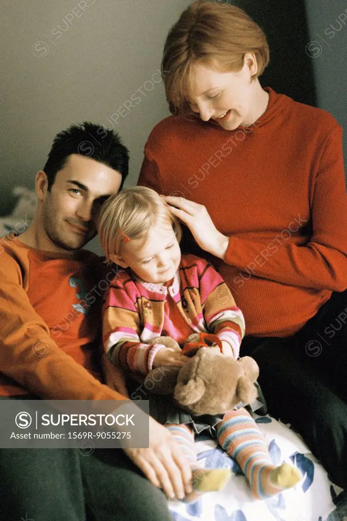 Family sitting together, mother touching daughter´s hair