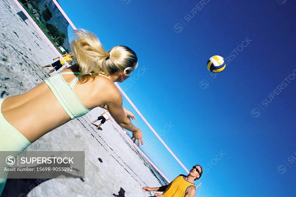 Female preparing to volley ball to teammate