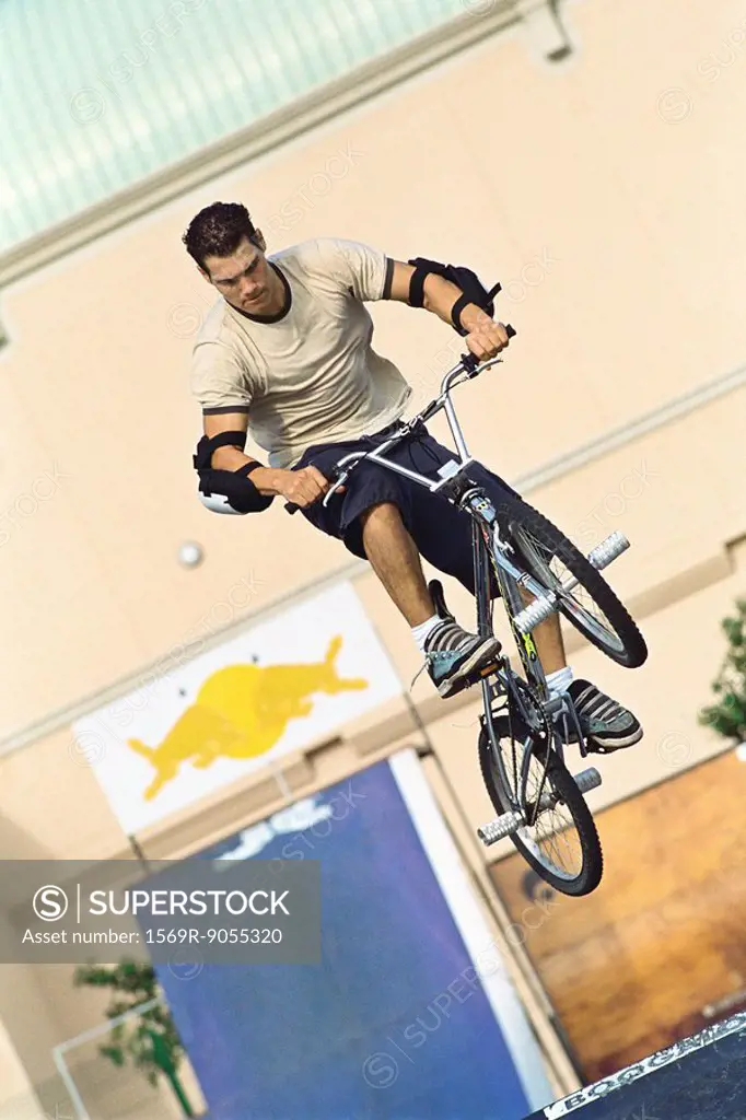 Cyclist doing midair trick at skatepark