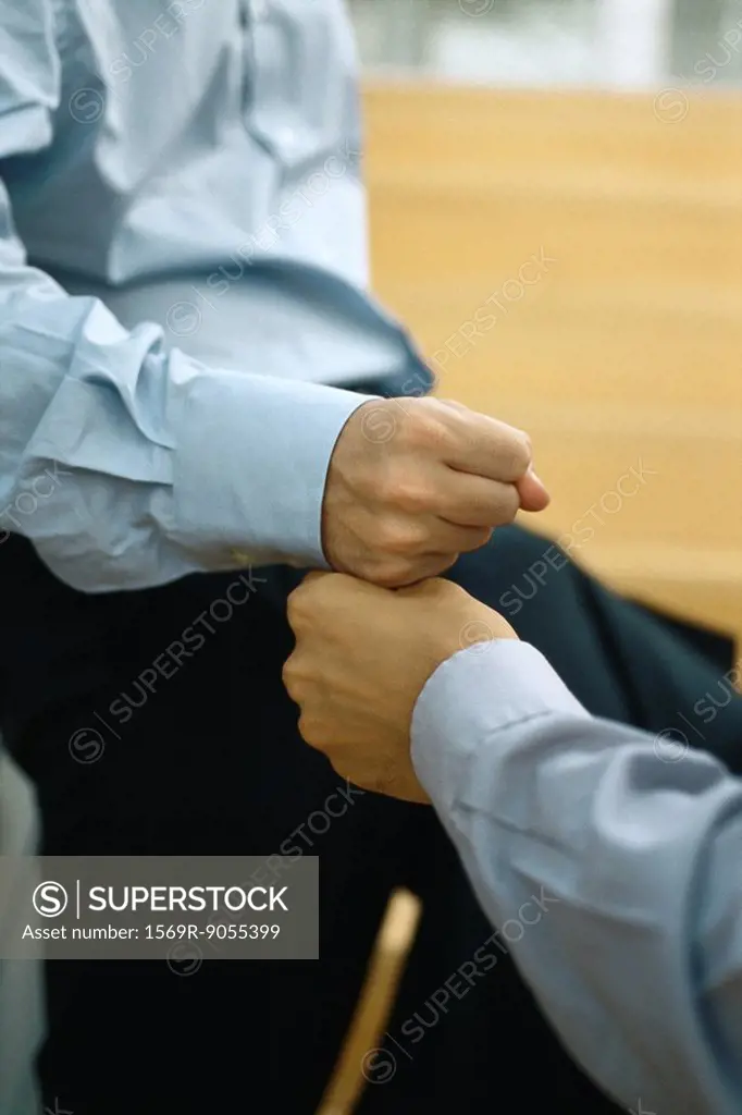 Two men touching fists