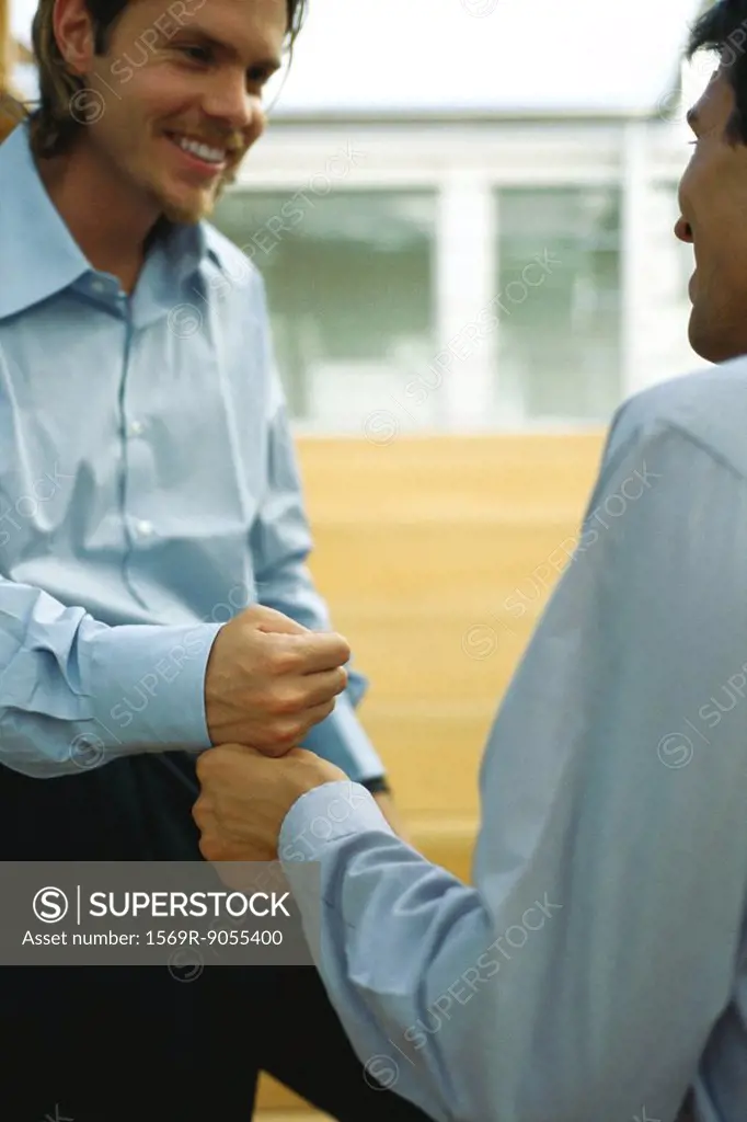 Two men touching fists