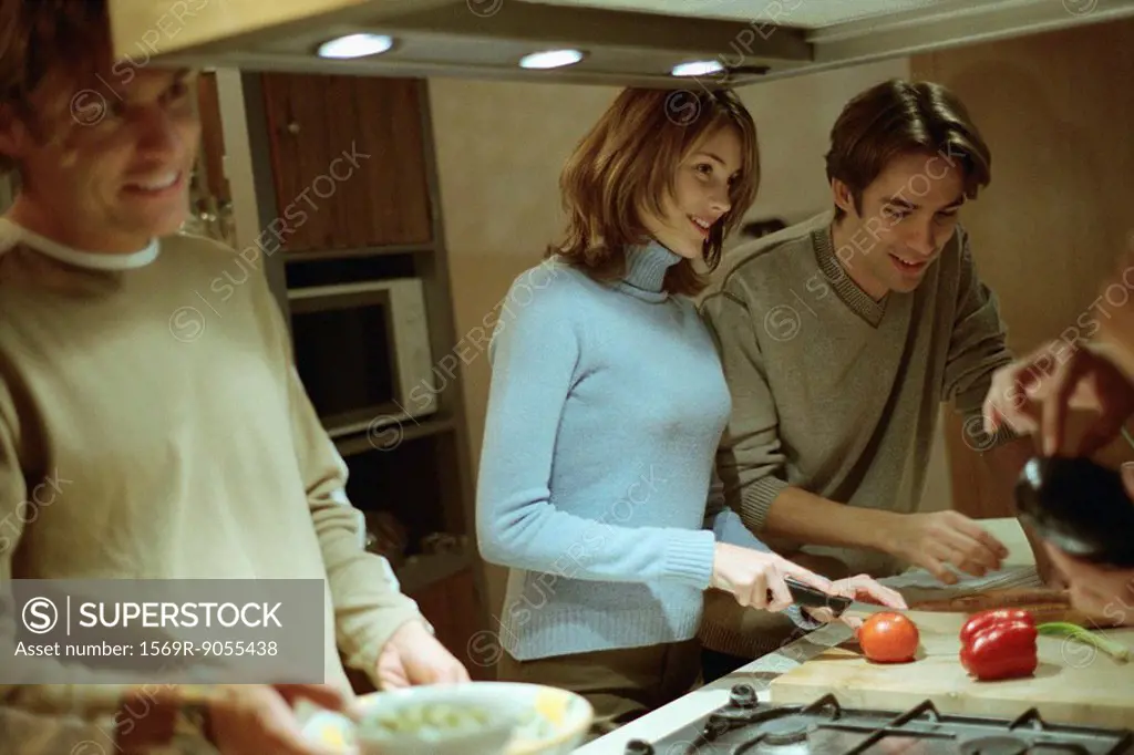 Friends preparing food in kitchen