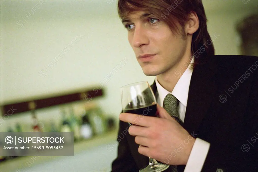 Young man with glass of wine