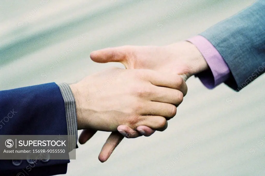 Hesitant handshake between professionals