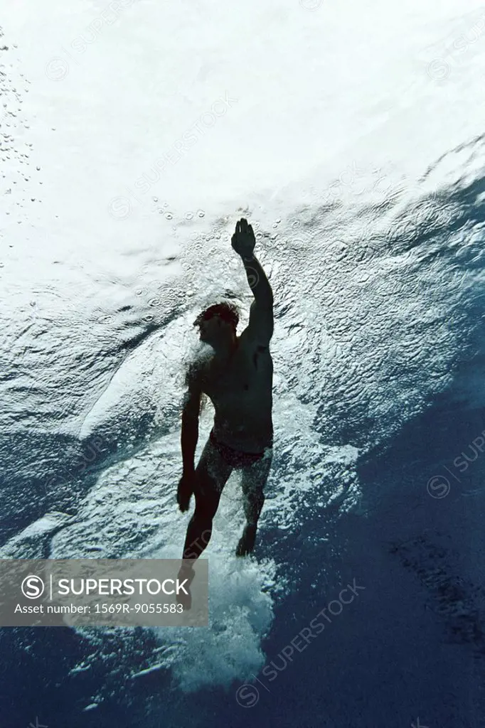 Man swimming in pool, underwater view