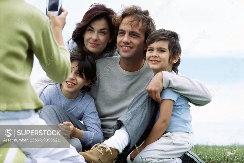 Child taking picture of family