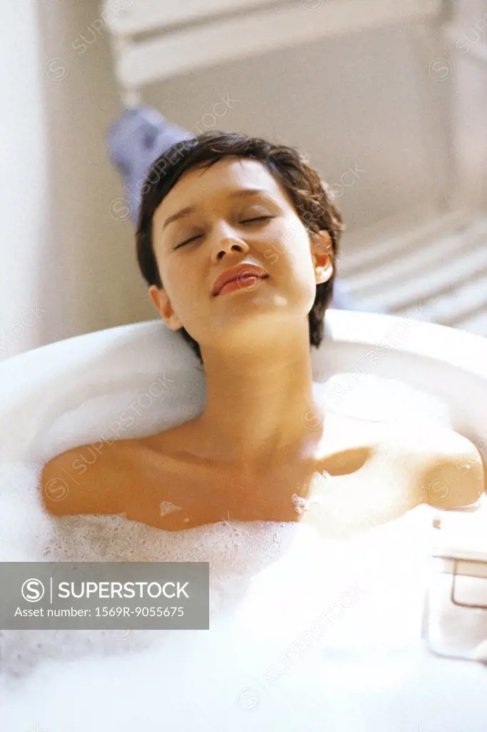 Woman taking bubble bath, relaxing