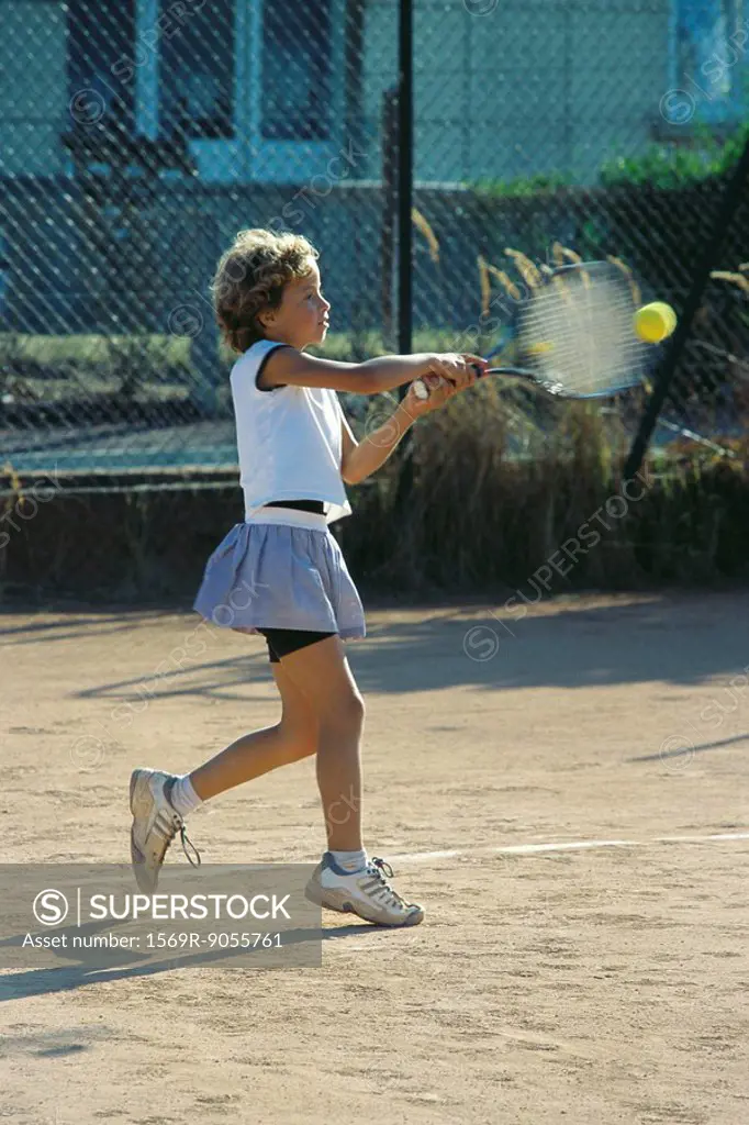 Little girl playing tennis
