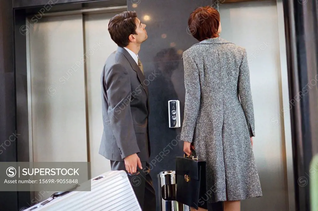 Business associates waiting for elevator