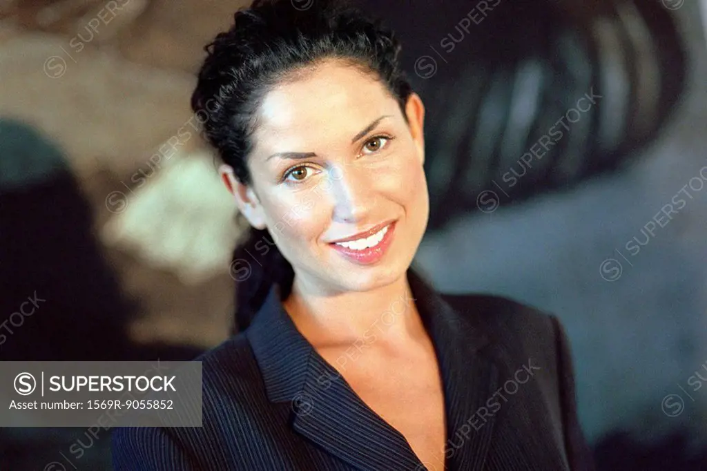 Young businesswoman smiling, portrait