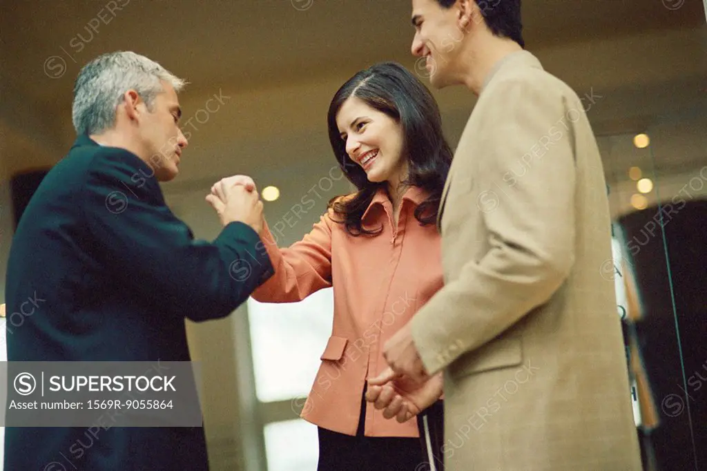 Businessman holding female colleague´s hand