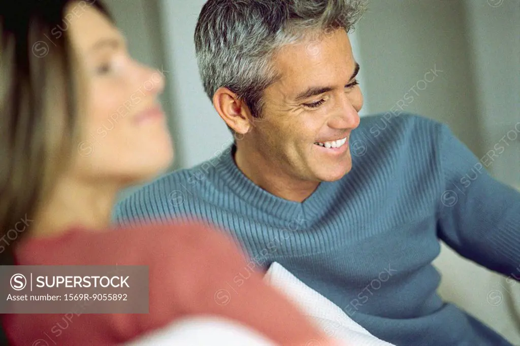 Couple smiling, laughing together, focus on man
