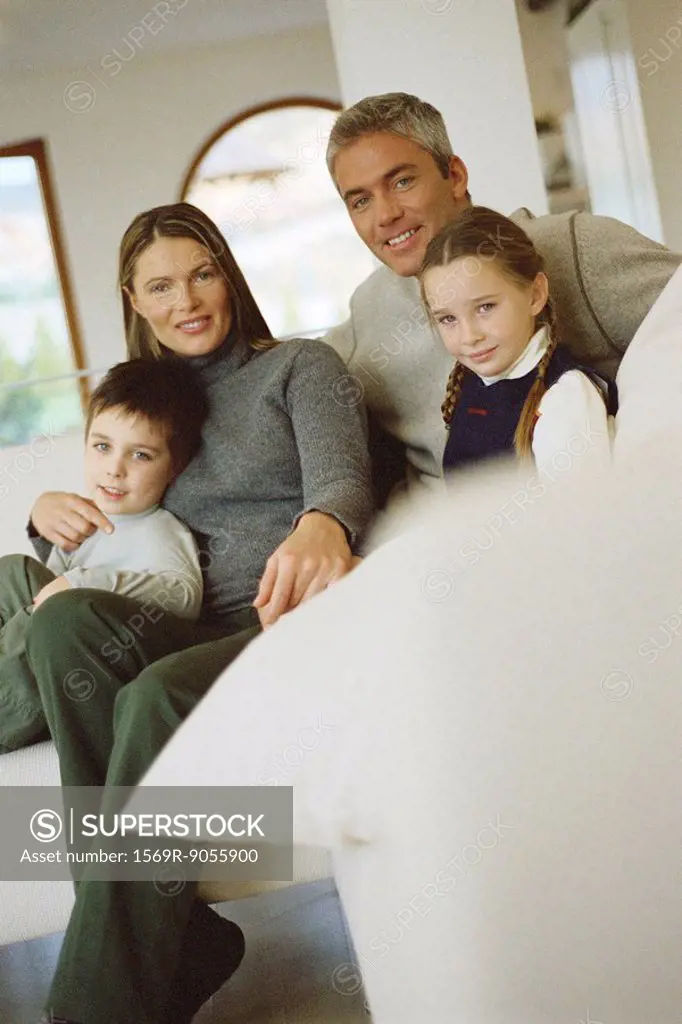 Family sitting together on sofa