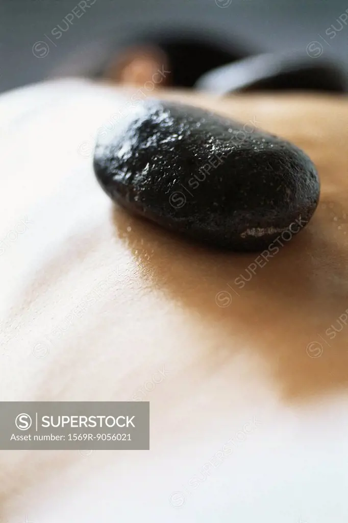 Lastone therapy, stone placed on patient´s bare back