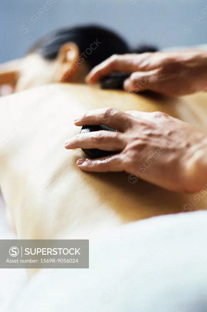 Lastone therapy, stones being positioned on patient´s bare back