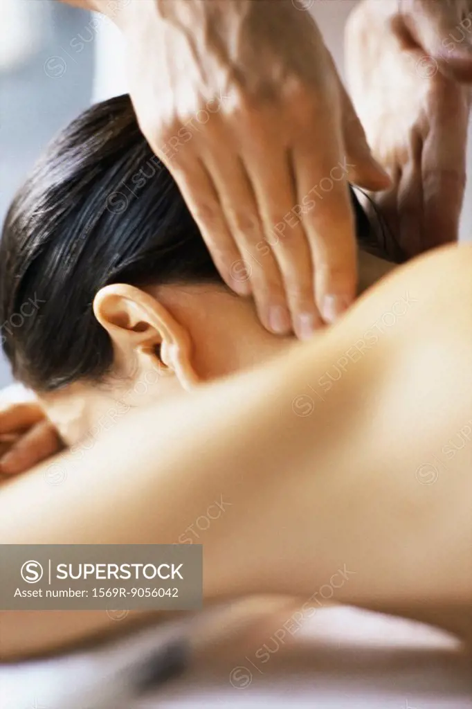Woman receiving neck massage, cropped view