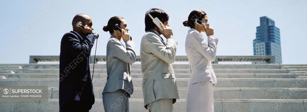 Professionally dressed men and women in line using successively more advanced phones