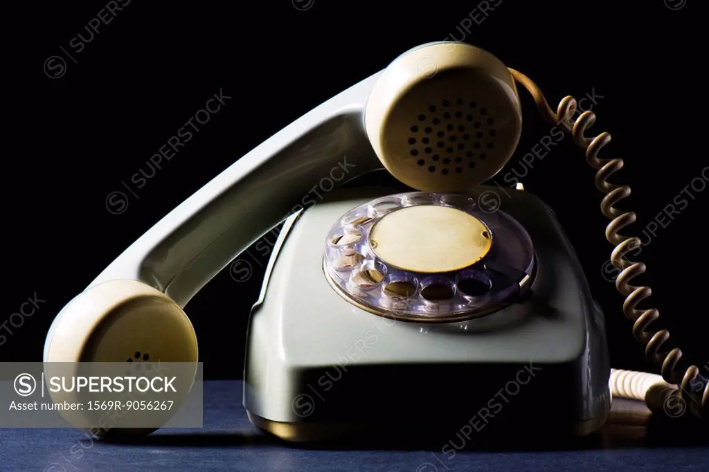 Rotary telephone with receiver off the hook, still life