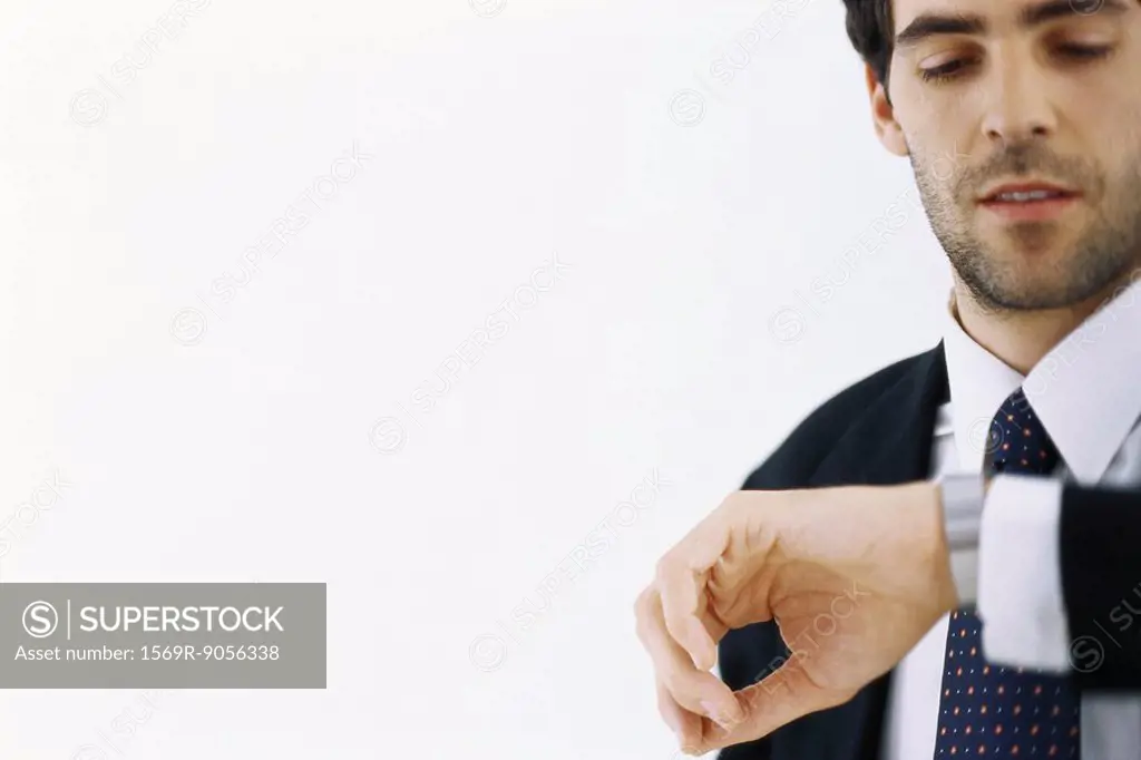 Businessman checking time, looking at watch