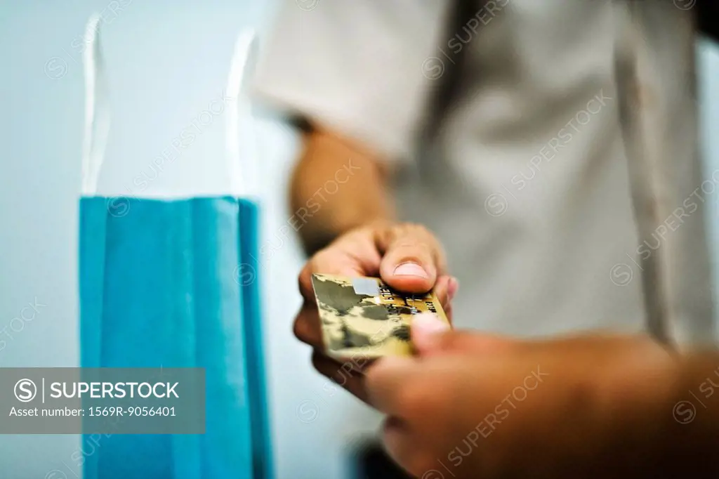 Man paying for purchase with credit card, cropped, close_up
