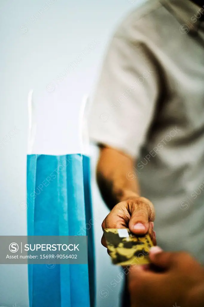 Man paying for purchase with credit card, cropped, close_up