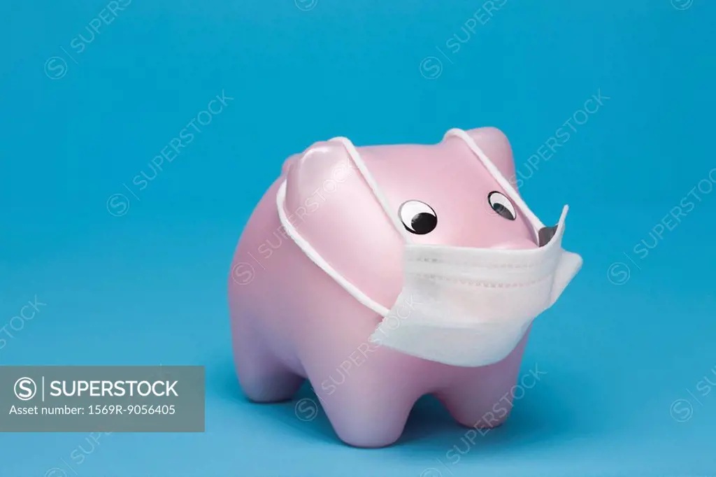 Swine flu concept, toy pig wearing flu mask