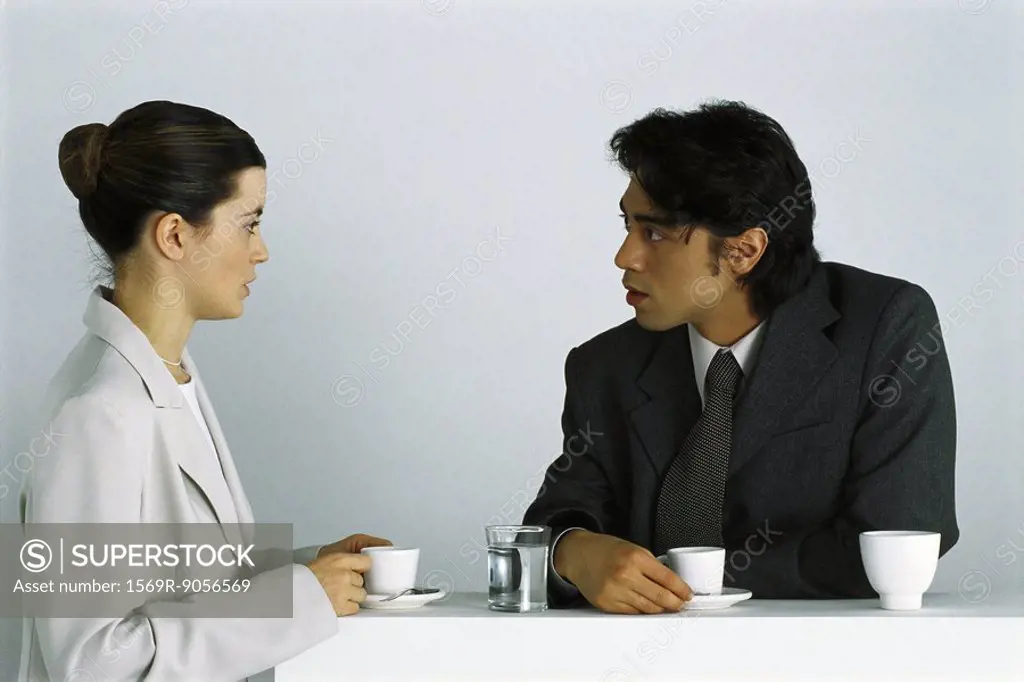 Male and female colleagues having coffee break together