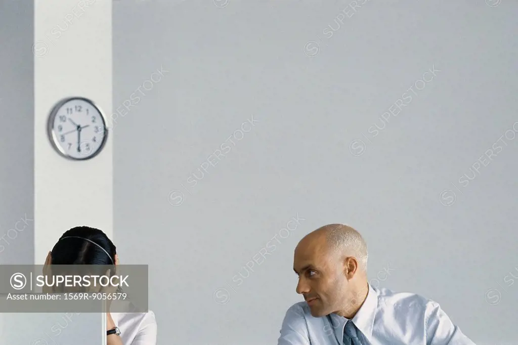 Office worker bothering female colleague