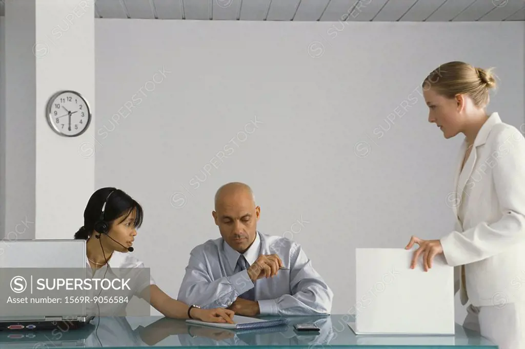Three business colleagues collaborating in office