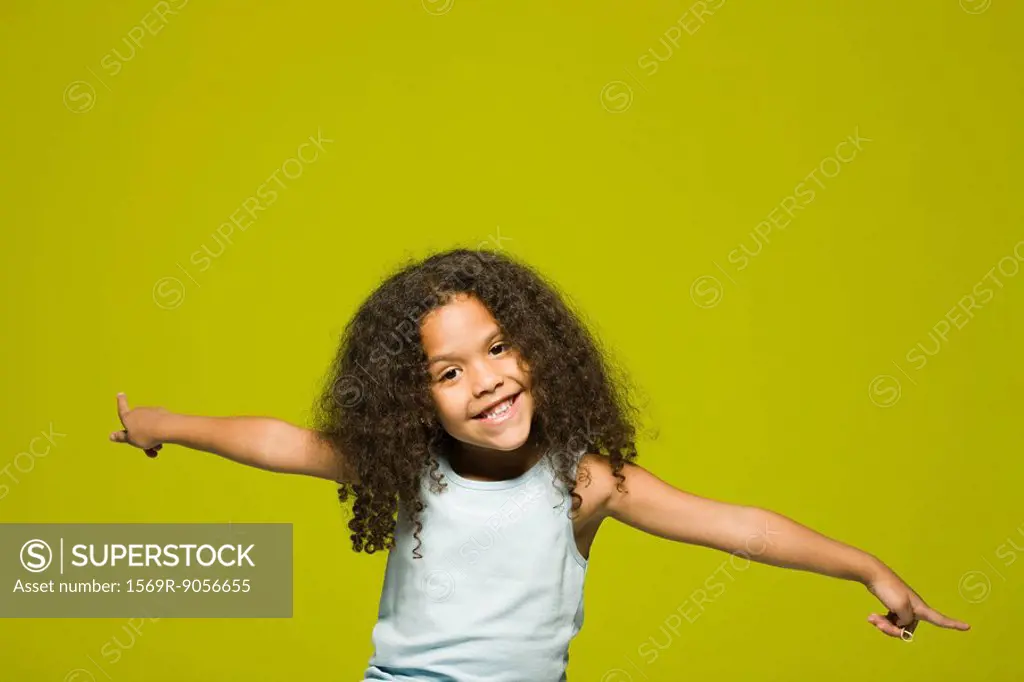 Little girl with arms outstretched, portrait
