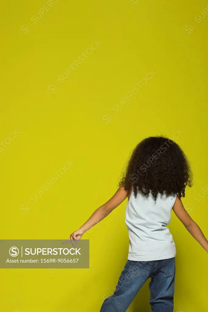 Little girl dancing, rear view