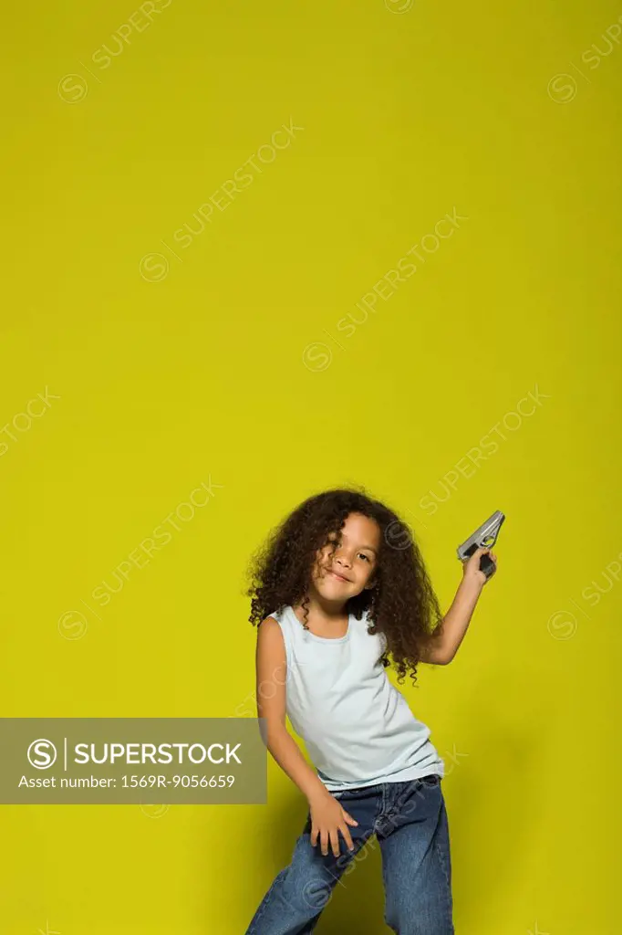 Little girl posing with toy gun