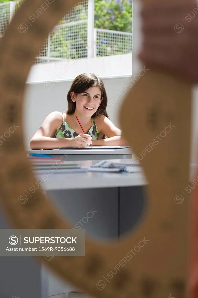 Female high school student in class, protractor in foreground