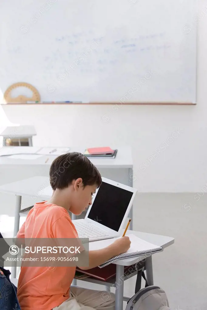 Elementary school student busy doing assignment in classroom