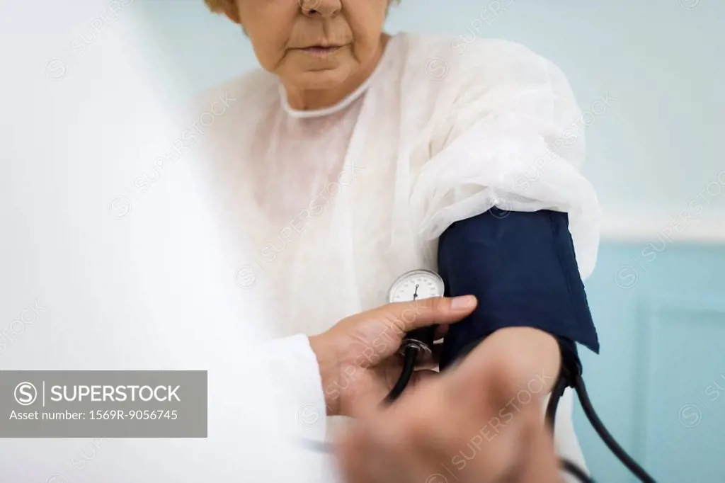 Doctor checking patient´s blood pressure, cropped