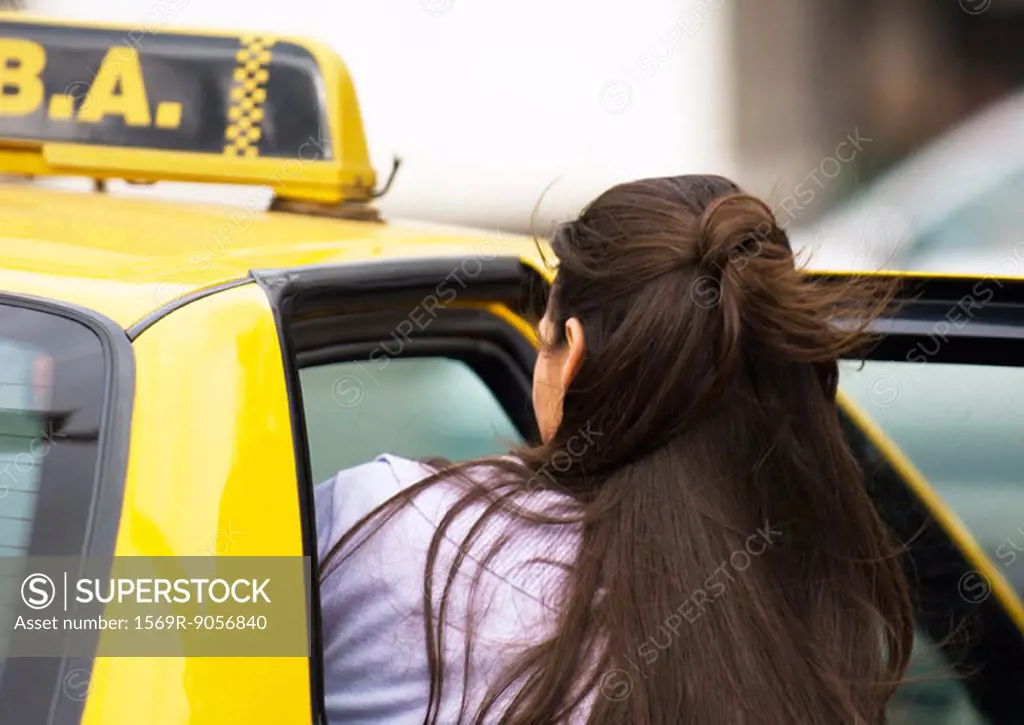 Woman getting in taxi