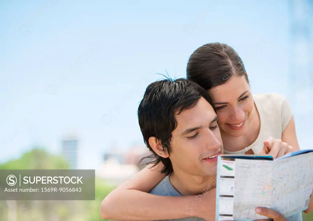 Young couple looking at map