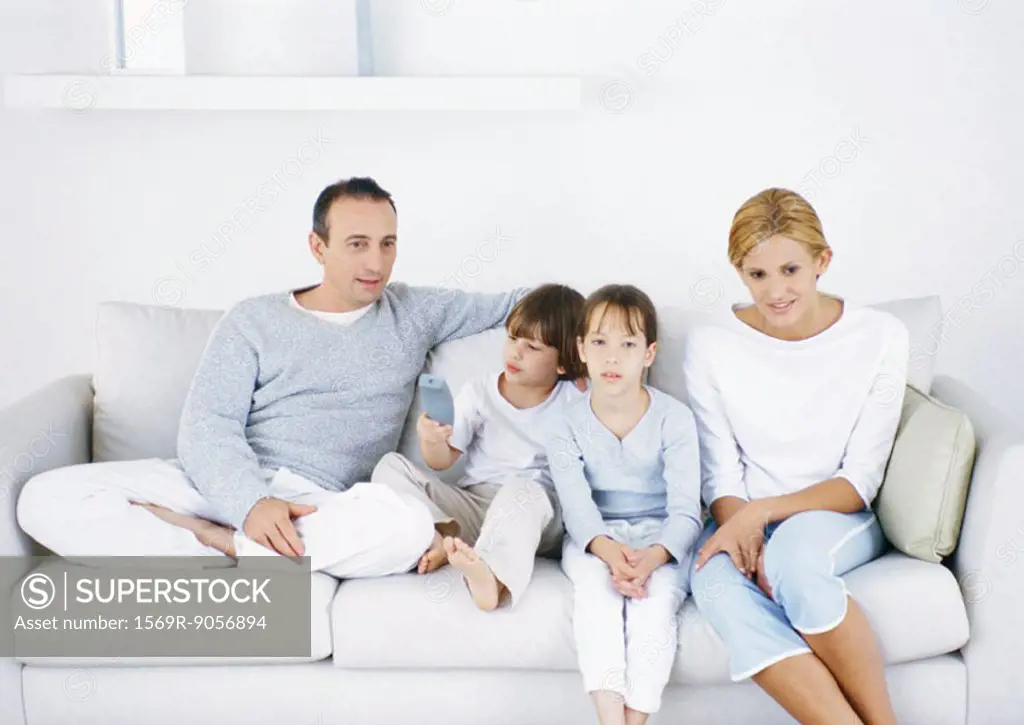 Family sitting on sofa together