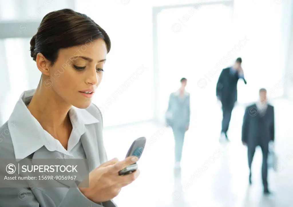 Young businesswoman checking phone