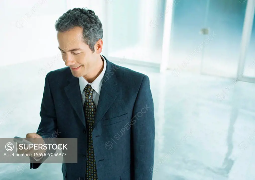 Businessman checking text messages on cell phone