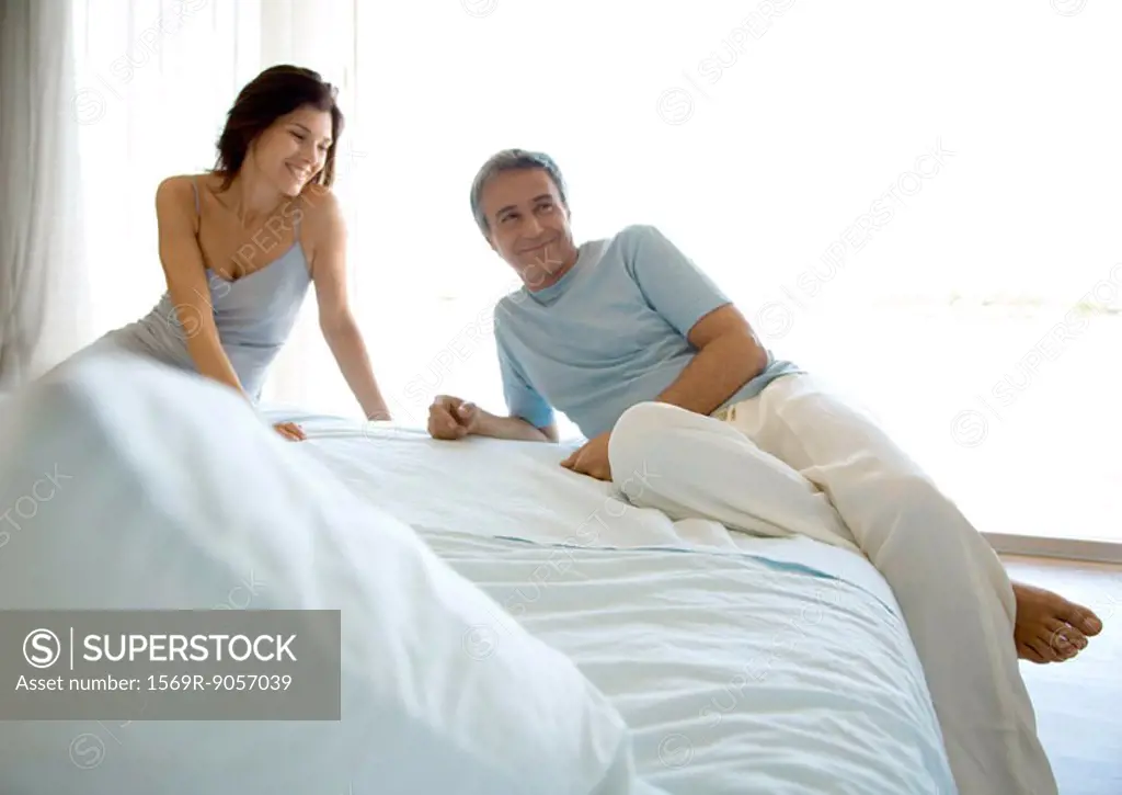 Couple lounging on bed